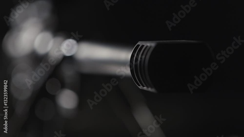 Sniper rifle with optical sight on black background, close-up, studio shot with shallow depth of field. Detailed view of sniper assault rifle. Refocus from sight to muzzle of sniper rifle. Front view.