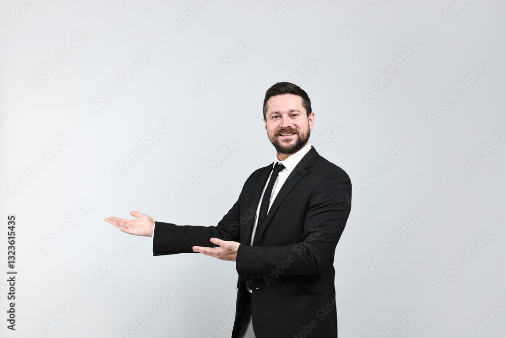 Happy businessman welcoming clients or partners on grey background Happy businessman welcoming clients or partners on grey background