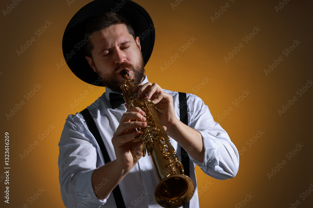 Naklejka premium Professional musician playing soprano saxophone on color background