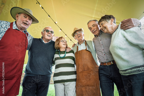 Konstfotografi Happy group of senior friends embracing and smiling at an outdoor party
