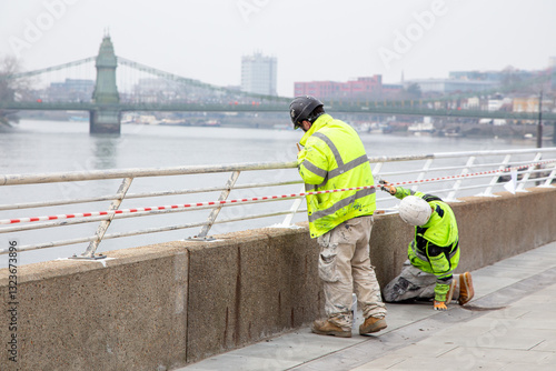 Workers in High Visibility Clothing by London Riverside in Hammersmith, London UK

