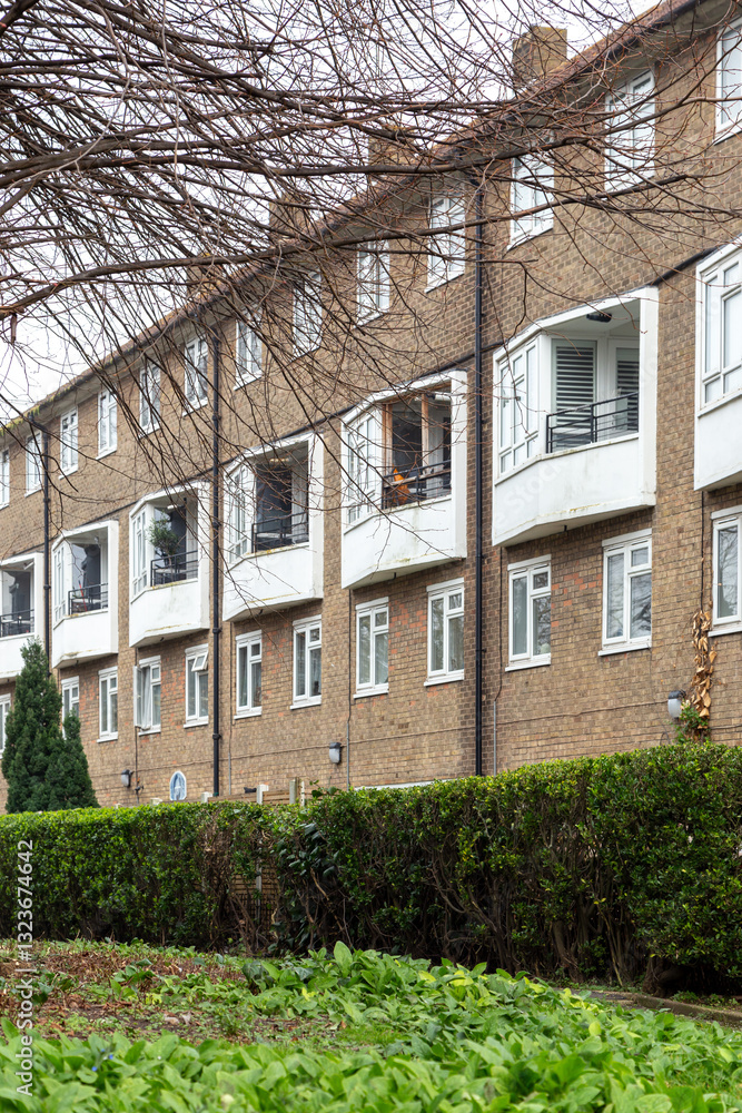 Fototapeta premium Exterior View of Brick Apartment Building in London Neighborhood. Vertical photo