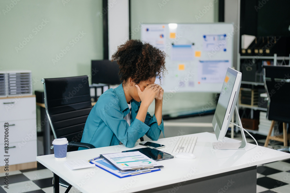 Asian business woman is stressed, bored, and overthinking from working on a tablet at the modern office.. Asian business woman is stressed, bored, and overthinking from working on a tablet at the modern office..