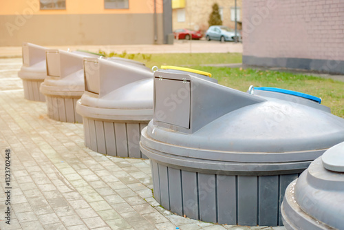 Obraz na płótnie Row of modern underground trash bins with cylindrical containers designed for efficient waste management, improving urban sanitation, sustainability, and space-saving garbage disposal solutions. w salonie
