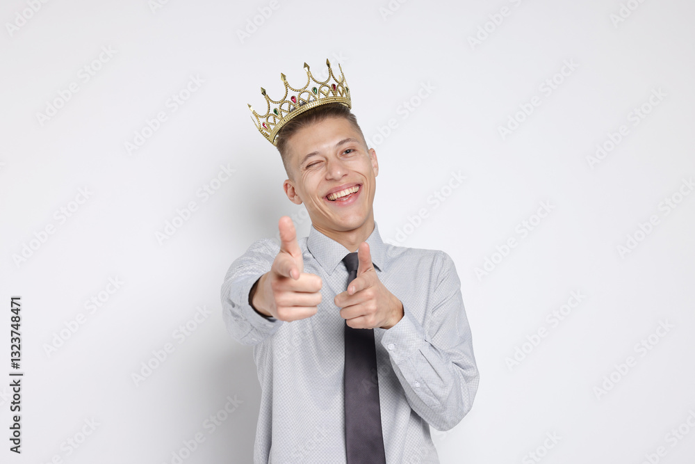 Handsome man wearing luxury crown on white background Handsome man wearing luxury crown on white background