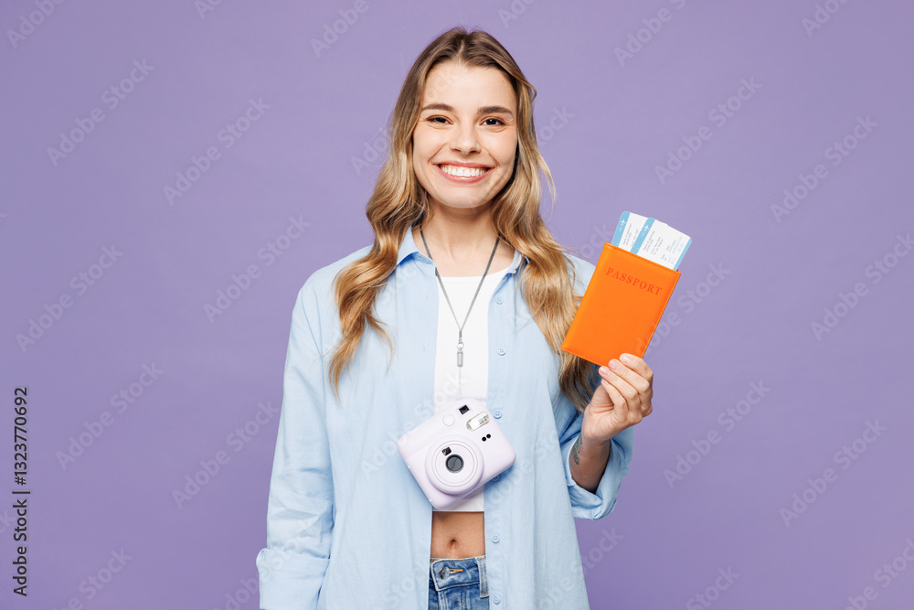 Traveler smiling woman wear blue clothes hold passport ticket look camera isolated on plain purple background. Tourist travel abroad in free spare time rest getaway. Air flight trip journey concept. Traveler smiling woman wear blue clothes hold passport ticket look camera isolated on plain purple background. Tourist travel abroad in free spare time rest getaway. Air flight trip journey concept.
