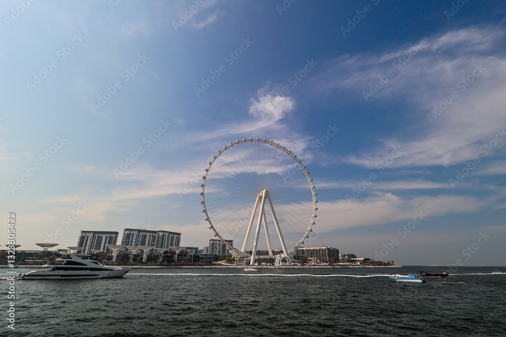 Obraz premium Dubai ferris wheel and city skyline from Jumeirah Beach. 2025