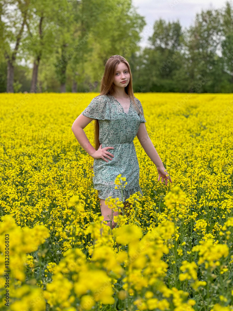 Young teenage girl with long hair in a field of yellow rapeseed flowers Young teenage girl with long hair in a field of yellow rapeseed flowers