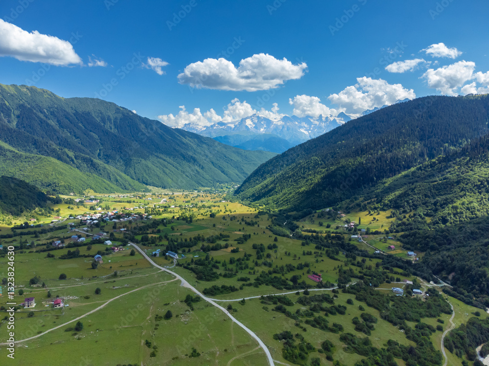 Stunning aerial view capturing to the village in svaneti, georgia, surrounded by majestic mountains, lush valleys, and traditional svan towers
