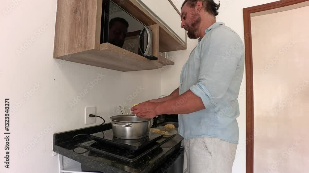 Man alone preparing a meal. Potatoes, pasta, chicken. Man alone preparing a meal. Potatoes, pasta, chicken.