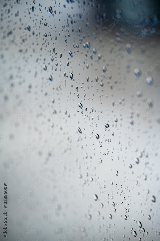 Water rain drops on a glass window, with shallow depth of field.