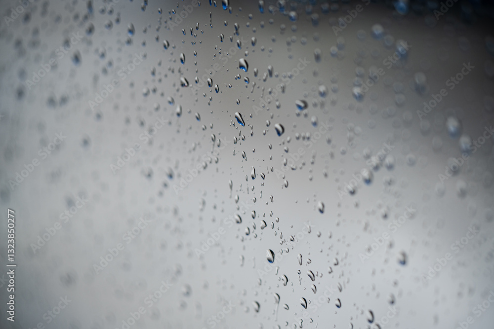 Water rain drops on a glass window, with shallow depth of field.