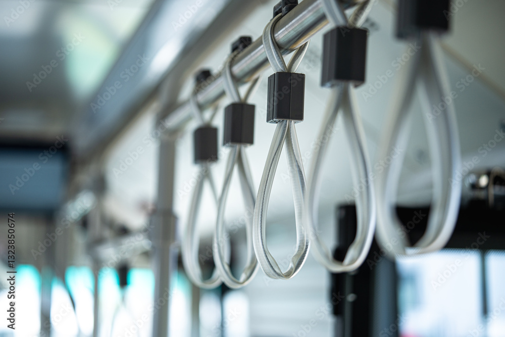 Close up shot of hand handles on public transport.