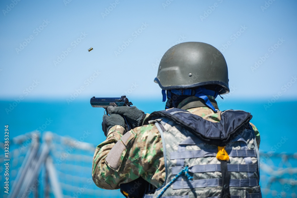 A special forces soldier fires a pistol and the bullet flies mid-air.