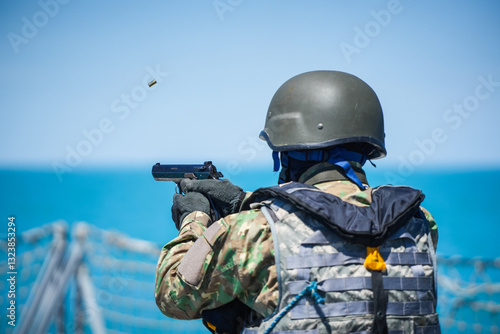 Obraz na płótnie A special forces soldier fires a pistol and the bullet flies mid-air. w salonie
