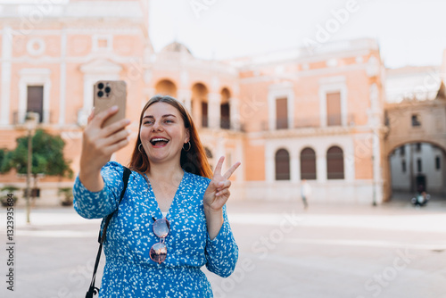 Obraz na płótnie Happy 30s Woman takes selfie on urban background. Traveler visiting Valencia Cathedral. Summer Holidays in Spain. Female is exploring city. Top tourist attraction w salonie