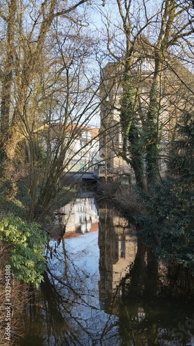 The castle is reflected in the green city stream