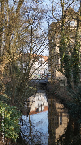 Beautiful old historical houses are reflected in the city flow.