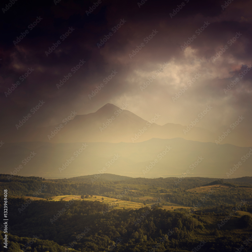 Fototapeta premium fantasy landscape with mountain peak over green hills