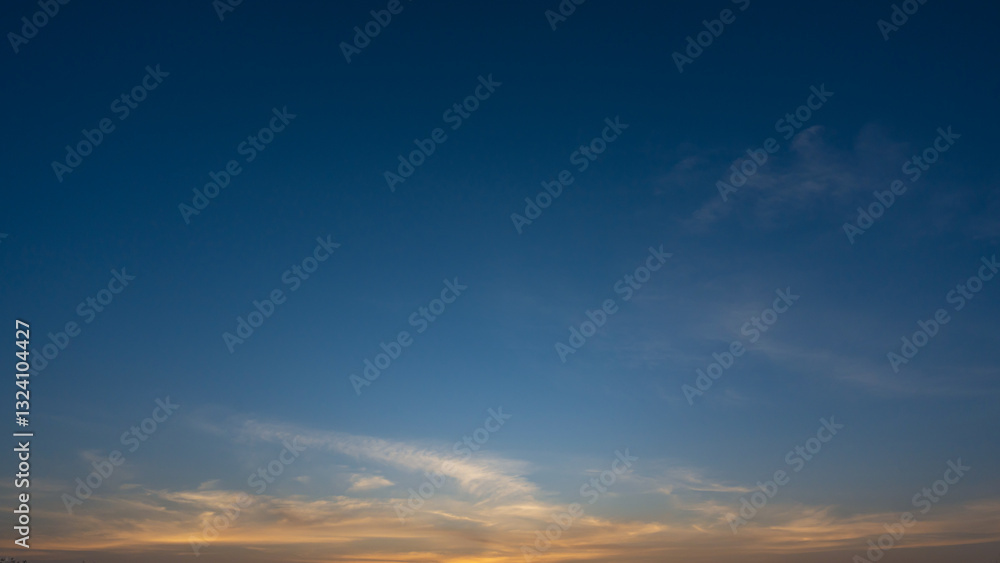 blue sky with soft wispy clouds at sunrise