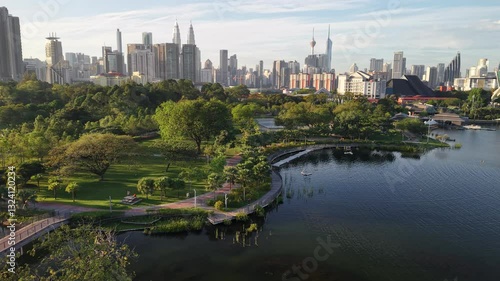 kuala lumpur park sunrise sun with blue lake and pedestrian jog