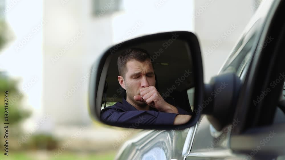 Young man inside car. A view in side mirror of guy sitting inside and caughing. Caught cold. Suffer from it in slow motion. Cover mouth with hand. Young man inside car. A view in side mirror of guy sitting inside and caughing. Caught cold. Suffer from it in slow motion. Cover mouth with hand.