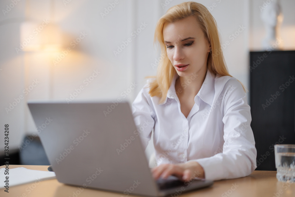 Woman working on her laptop in the office. Woman working on her laptop in the office.