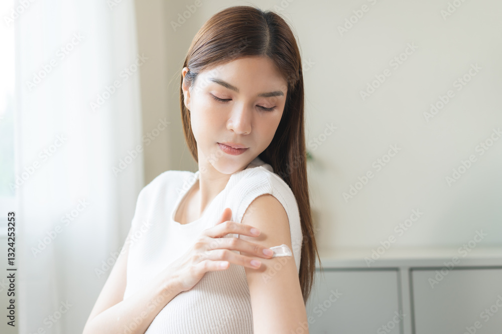 Health skin care, beauty smile asian young woman, girl hand applying, putting moisturizer on her arm, shoulder after shower bath at home. Skin body cream moisturizing lotion, routine in the morning. Health skin care, beauty smile asian young woman, girl hand applying, putting moisturizer on her arm, shoulder after shower bath at home. Skin body cream moisturizing lotion, routine in the morning.