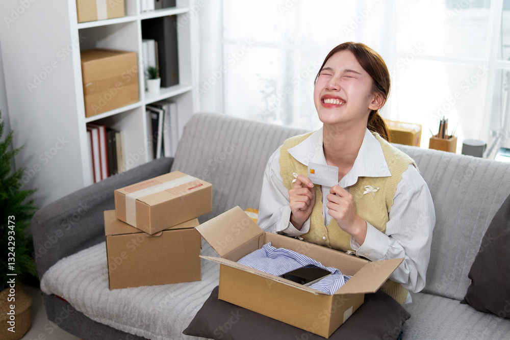 A young woman is delighted to receive a package she ordered online. A young woman is delighted to receive a package she ordered online.