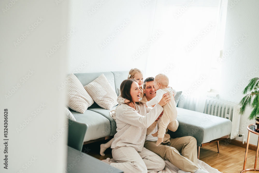 Beautiful happy young family with small children resting at home. Beautiful happy young family with small children resting at home.