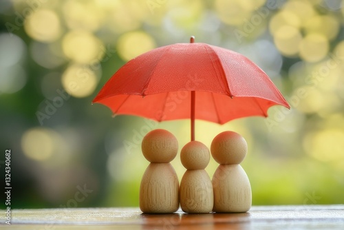 Wallpaper Mural Wooden Figurines Under Bright Red Umbrella with Soft Focus Background for Family Concept Torontodigital.ca