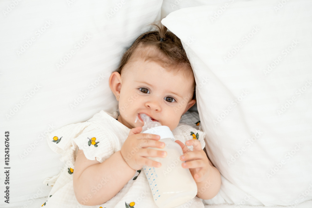 a baby with a bottle of milk or formula in his hands in a bright bedroom, a space for text, a baby food concept, a small child sucking a pacifier with a bottle a baby with a bottle of milk or formula in his hands in a bright bedroom, a space for text, a baby food concept, a small child sucking a pacifier with a bottle