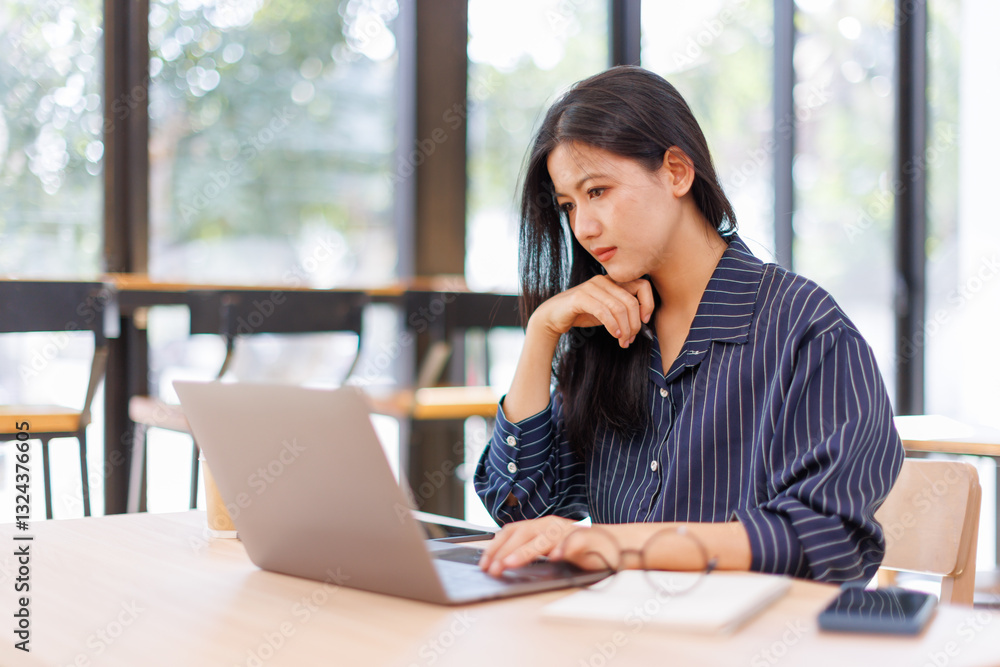 Portrait of tired young business Asian woman work with documents tax laptop computer in office. Sad, unhappy, Worried, Depression, or employee life stress concept Portrait of tired young business Asian woman work with documents tax laptop computer in office. Sad, unhappy, Worried, Depression, or employee life stress concept