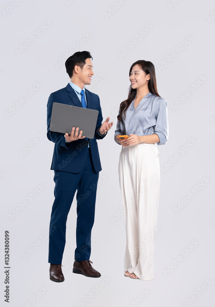 Full body image of young asian business couple using laptop and phone on white background Full body image of young asian business couple using laptop and phone on white background