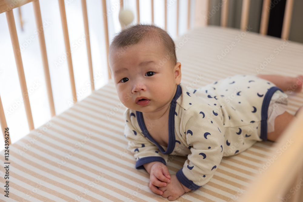 Little baby boy crawling in his crib