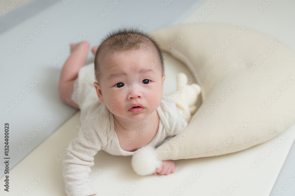 Cute baby lying on soft white bed