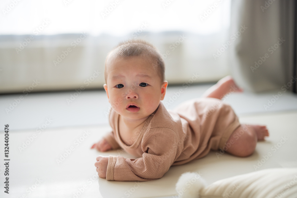Baby lying on tummy at home floor