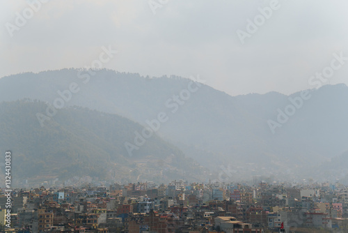 Cityscape of Kathmandu, the capital of Nepal, with mountains in the background and smog