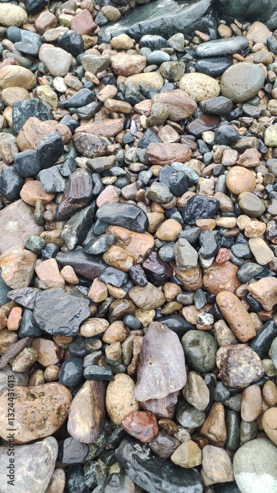 Natural Beach Stones Background with Various Colors and Shapes Natural Beach Stones Background with Various Colors and Shapes