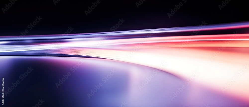 Fototapeta premium A dynamic, colorful light trail against a dark background, conveying movement and energy.