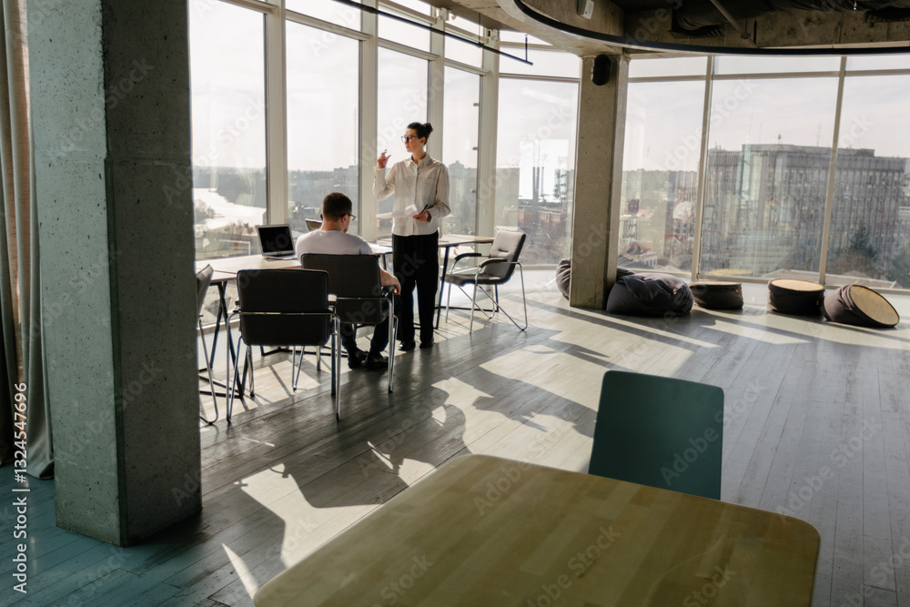Fototapeta premium Two office workers working together 