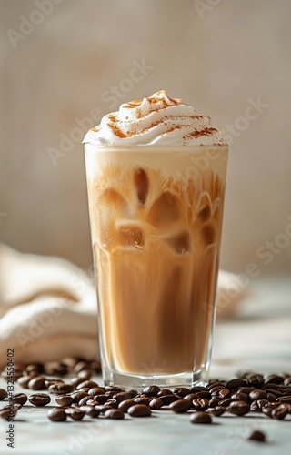 Delicious Iced Coffee Topped With Whipped Cream and Cinnamon Served in a Tall...