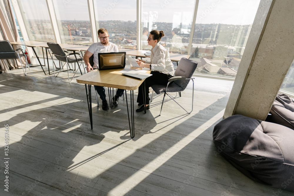Two office workers working to together Two office workers working to together