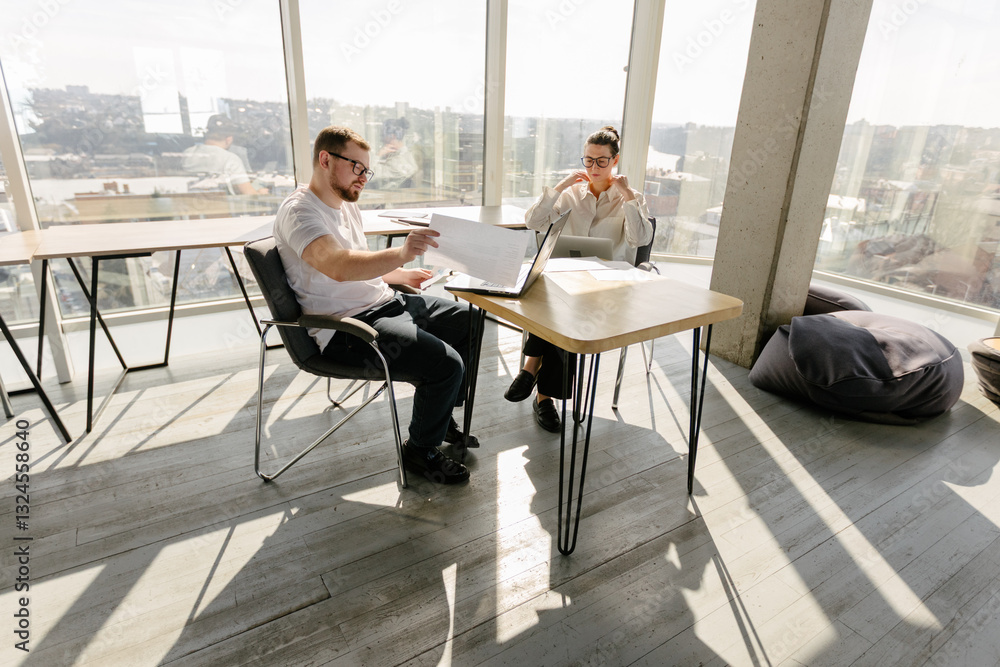 Two office workers working to together Two office workers working to together