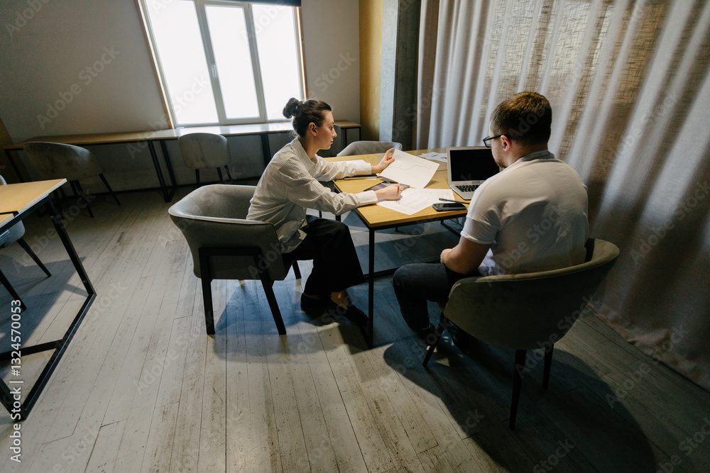 Two office workers working to together Two office workers working to together