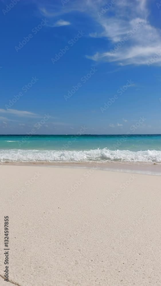 HD vertical video on a sandy tropical deserted beach with gentle waves crashing on the shore. In the background the turquoise Caribbean Sea and blue sky. Eco-friendly travel and vacation concept HD vertical video on a sandy tropical deserted beach with gentle waves crashing on the shore. In the background the turquoise Caribbean Sea and blue sky. Eco-friendly travel and vacation concept
