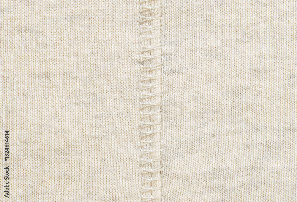 Fototapeta premium Soft beige cotton melange jersey fabric with a overlock seam detail in the center texture or background