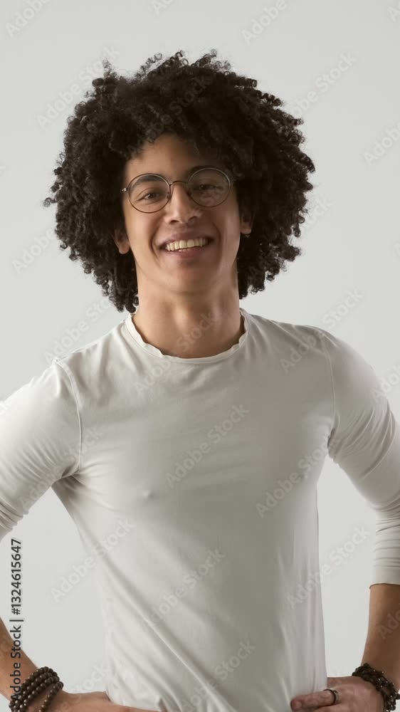 Joyful African American man shows a thumbs up or like gesture for approve or confirm with a smile on a white background. Vertical video. Joyful African American man shows a thumbs up or like gesture for approve or confirm with a smile on a white background. Vertical video.