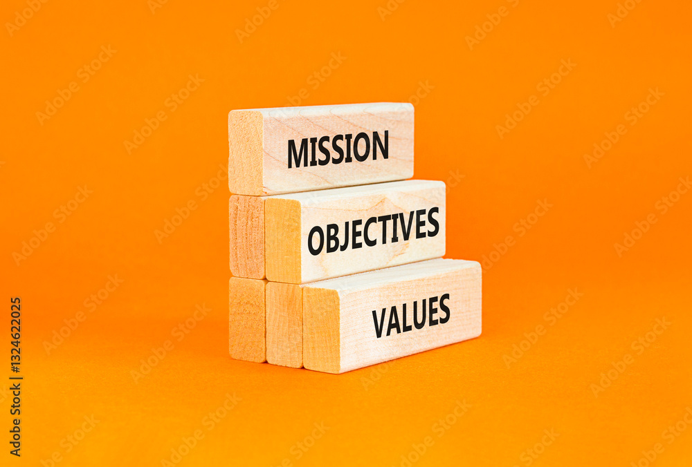 Naklejka premium Mission objectives values symbol. Concept words Mission Objectives Values on beautiful blocks. Beautiful orange table orange background. Business mission objectives values concept. Copy space.