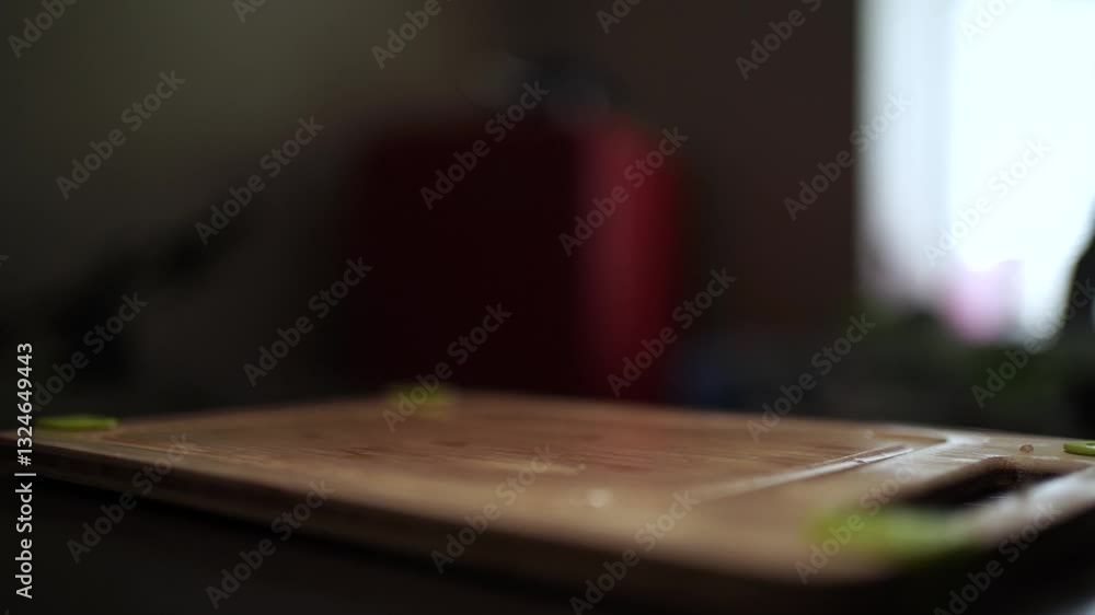 Close-Up of Hands Slicing Fresh Salmon Fillet on a Dark Background Close-Up of Hands Slicing Fresh Salmon Fillet on a Dark Background